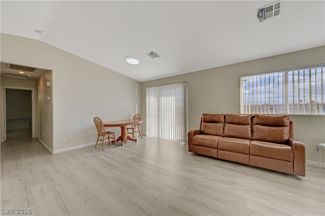 2025 Hollow Oak Avenue, North Las Vegas, NV 89031 Light-toned wood floors and high vaulted ceilings define this airy living space.