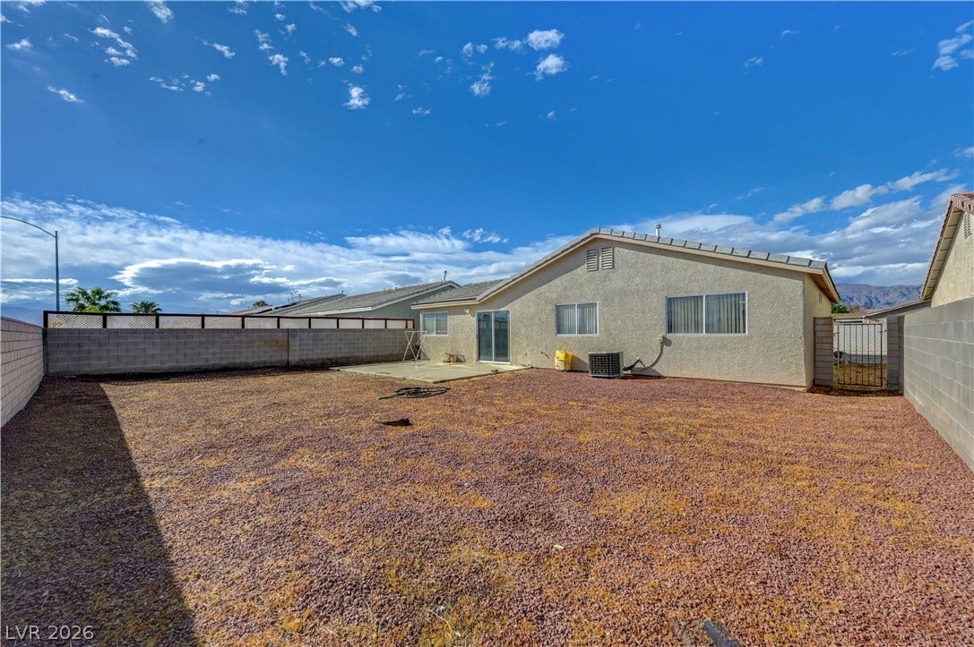 2025 Hollow Oak Avenue, North Las Vegas, NV 89031 A spacious backyard enclosed by block fencing features low-maintenance gravel landscaping.