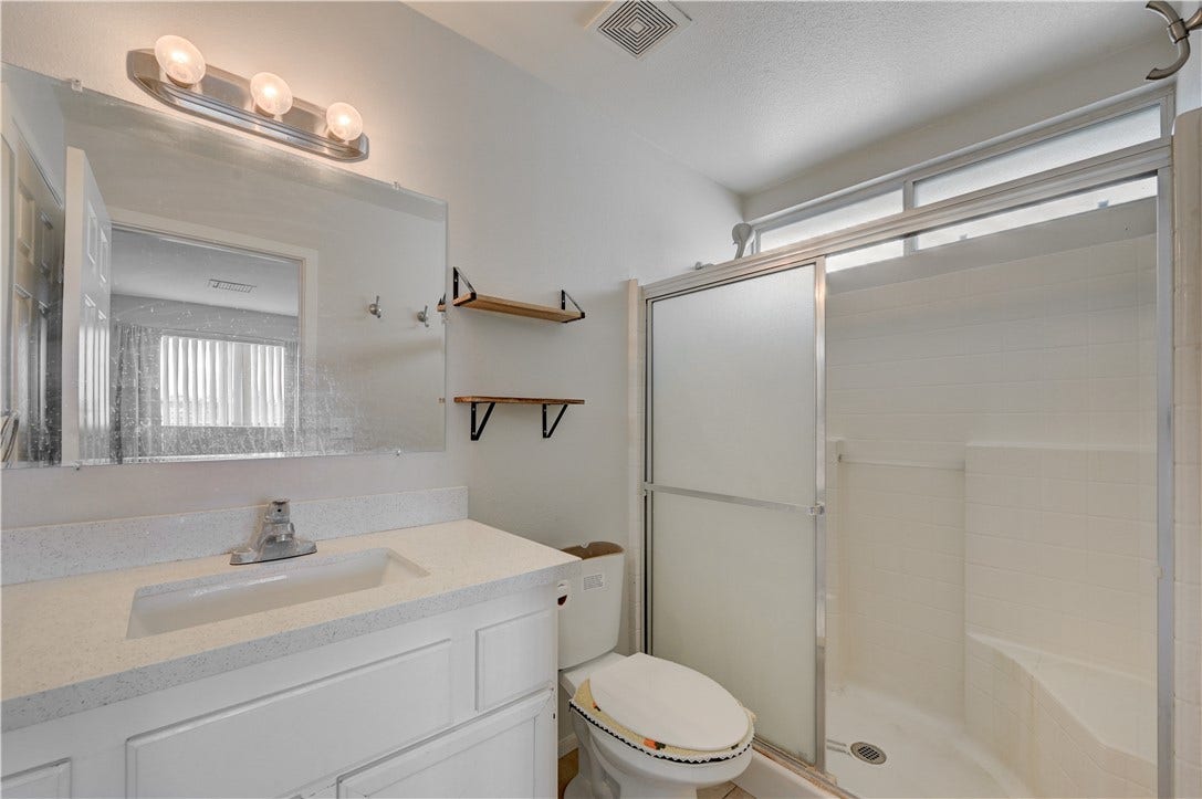 2025 Hollow Oak Avenue, North Las Vegas, NV 89031 Clean lines and a walk-in shower define this functional bathroom.