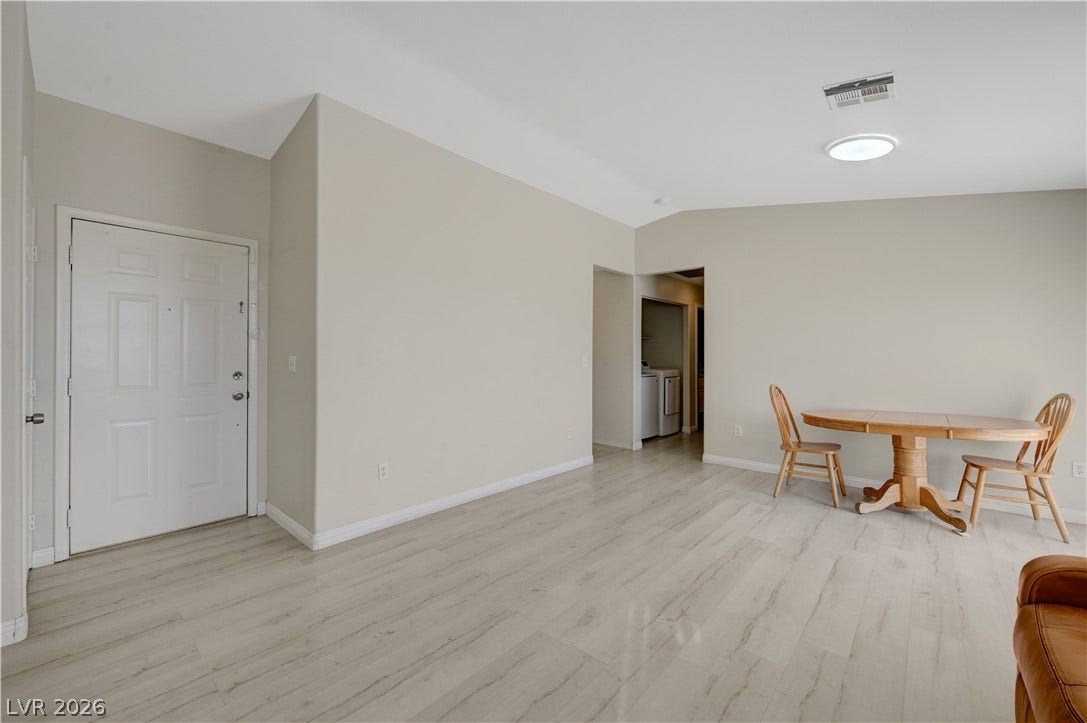 2025 Hollow Oak Avenue, North Las Vegas, NV 89031 High vaulted ceilings and light wood floors create an airy open layout near the entryway.