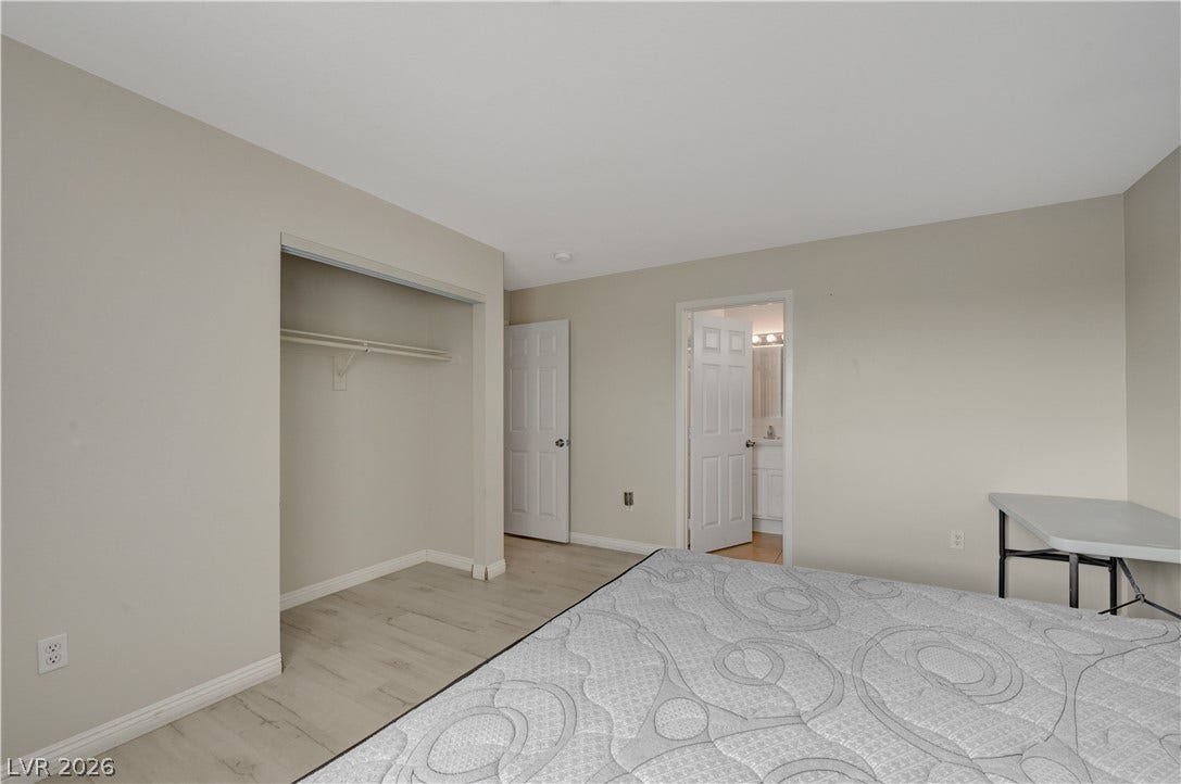 2025 Hollow Oak Avenue, North Las Vegas, NV 89031 Smooth plaster walls and neutral wood-inspired flooring define this functional sleeping space.