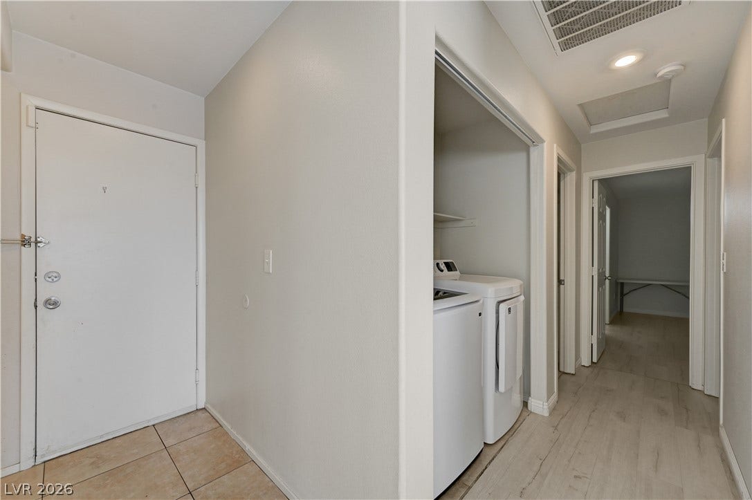 2025 Hollow Oak Avenue, North Las Vegas, NV 89031 Functional layout transitions smoothly from tiled entry past a laundry nook into wood-look flooring.