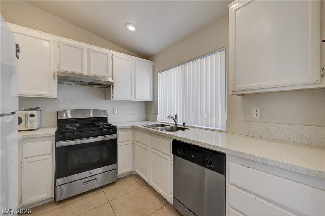 2025 Hollow Oak Avenue, North Las Vegas, NV 89031 Bright tile flooring and solid countertops anchor this functional kitchen layout.