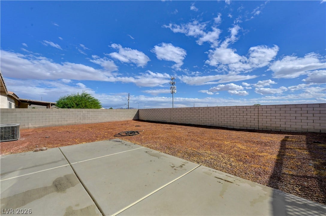 2025 Hollow Oak Avenue, North Las Vegas, NV 89031 An expansive concrete patio overlooks the private backyard enclosed by tall block walls.