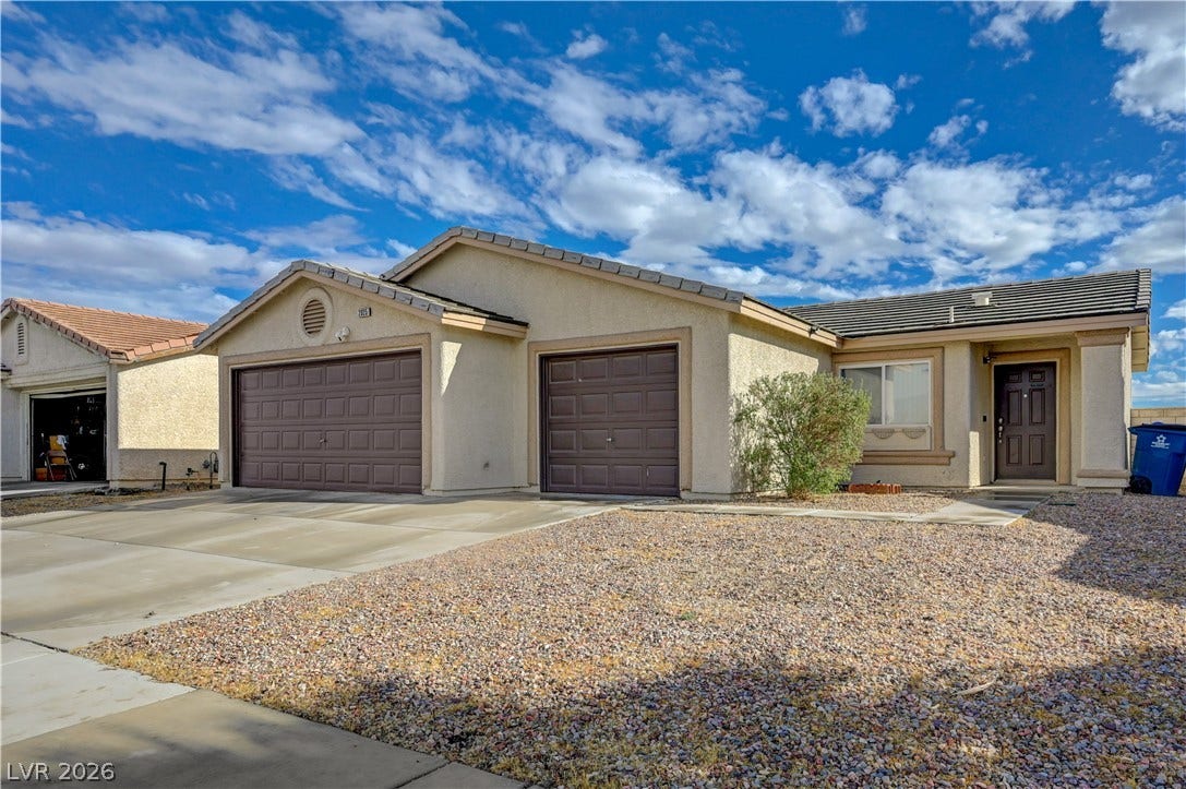 2025 Hollow Oak Avenue, North Las Vegas, NV 89031 Stucco exterior siding and tile roofing define this classic single-story home.
