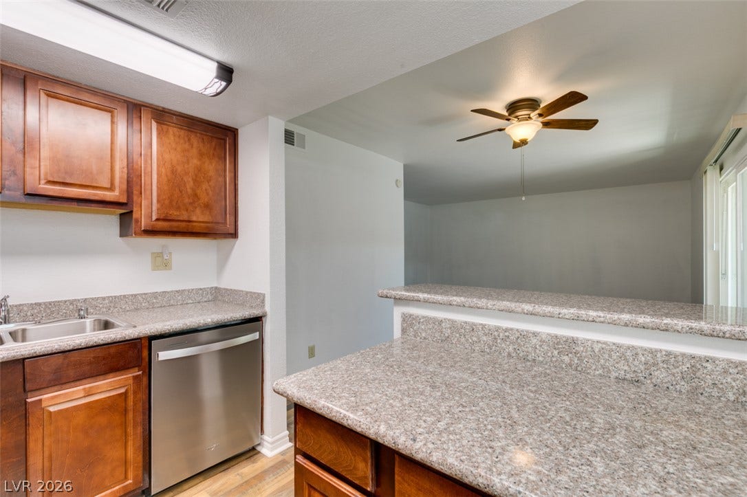 5240 Indian River Drive, #273, Las Vegas, NV 89103 Granite counters and rich wood cabinetry define this functional culinary space.