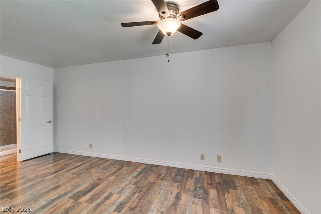 5240 Indian River Drive, #273, Las Vegas, NV 89103 Rich wood-textured flooring complements the clean, neutral walls in this versatile bedroom.