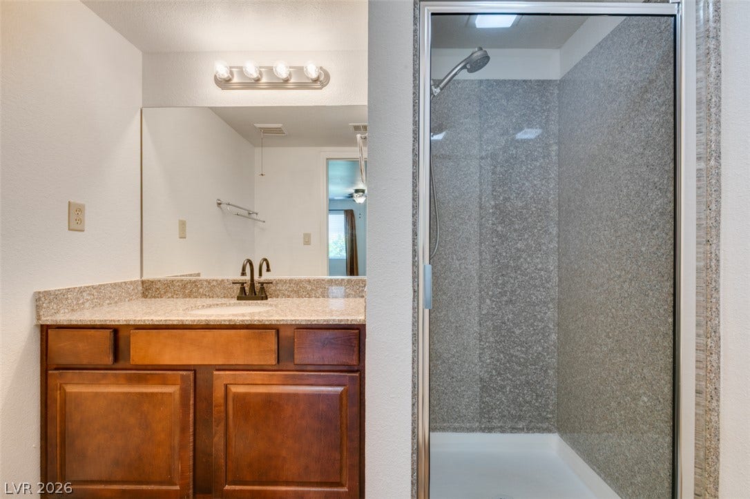5240 Indian River Drive, #273, Las Vegas, NV 89103 A classic wood vanity and glass-enclosed shower maximize utility in this functional layout.