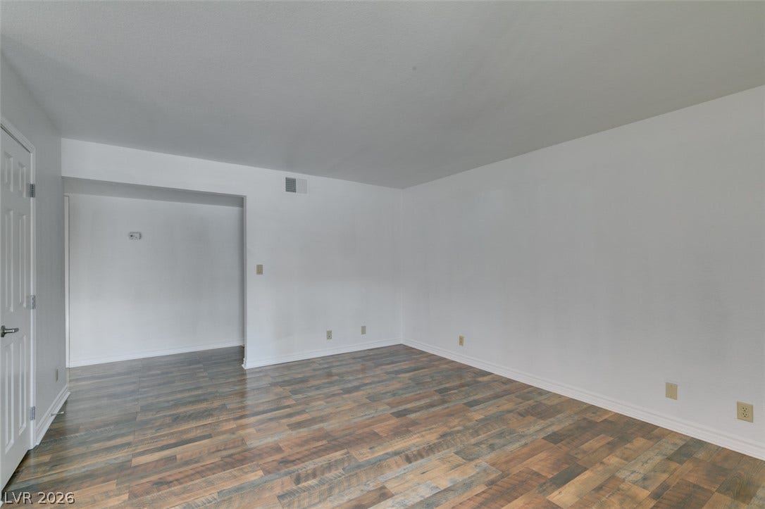 5240 Indian River Drive, #273, Las Vegas, NV 89103 Richly textured wood-look flooring anchors this clean interior space.