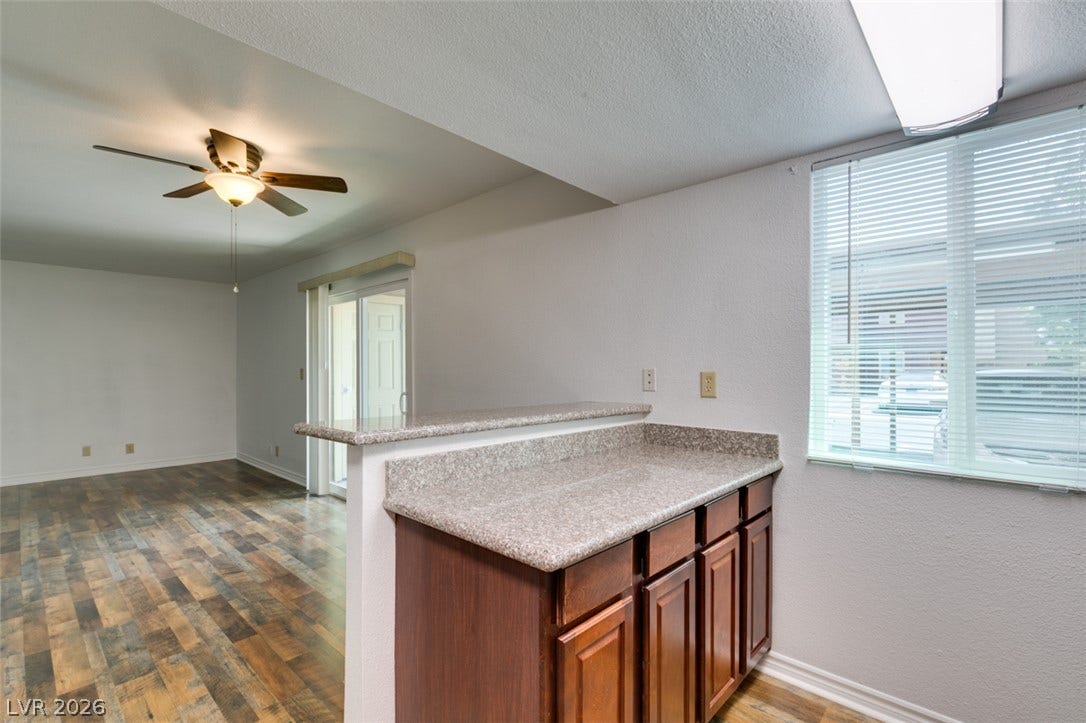 5240 Indian River Drive, #273, Las Vegas, NV 89103 Gleaming wood-look flooring connects the versatile dining counter directly to the open living space.