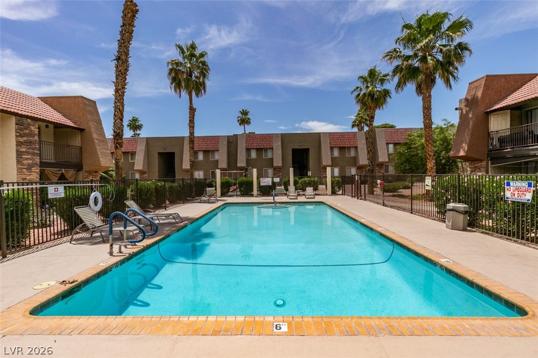 5240 Indian River Drive, #273, Las Vegas, NV 89103 A sparkling community pool offers a refreshing escape surrounded by towering palm trees.