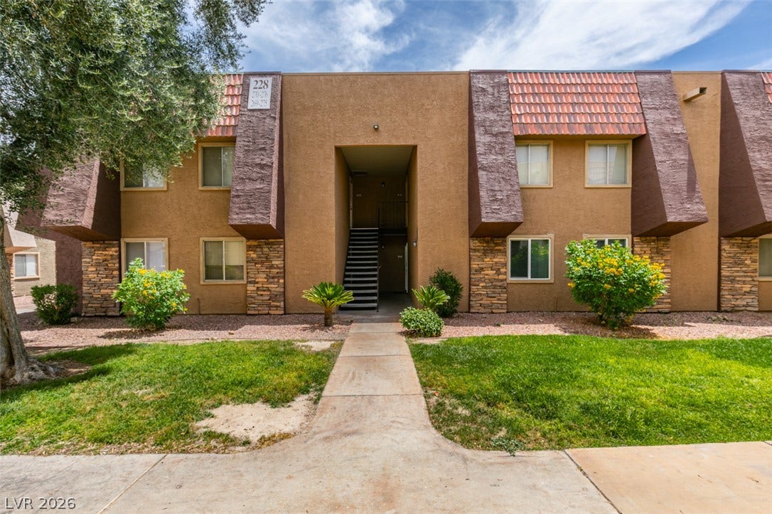 5240 Indian River Drive, #273, Las Vegas, NV 89103 Manicured green lawns flank a concrete path leading to the entrance of this multi-story building.