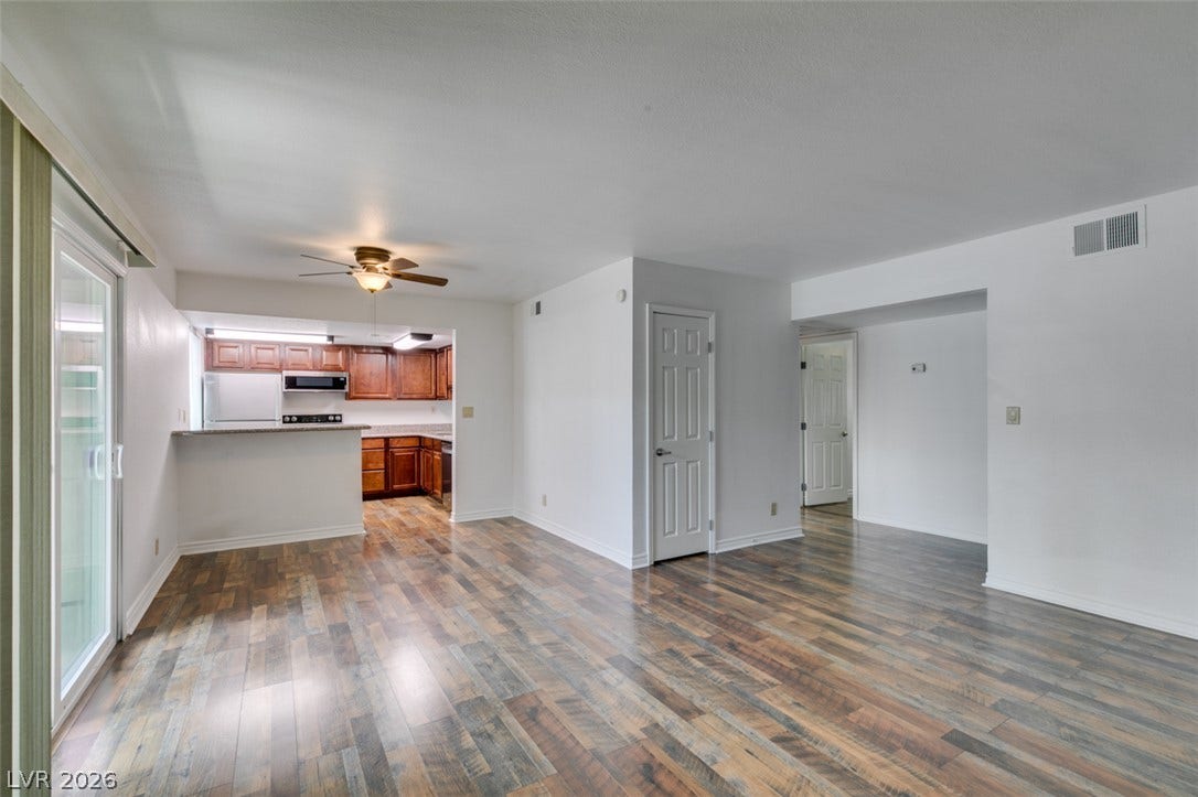 5240 Indian River Drive, #273, Las Vegas, NV 89103 Gleaming wood-look floors anchor this airy living space adjacent to the kitchen.