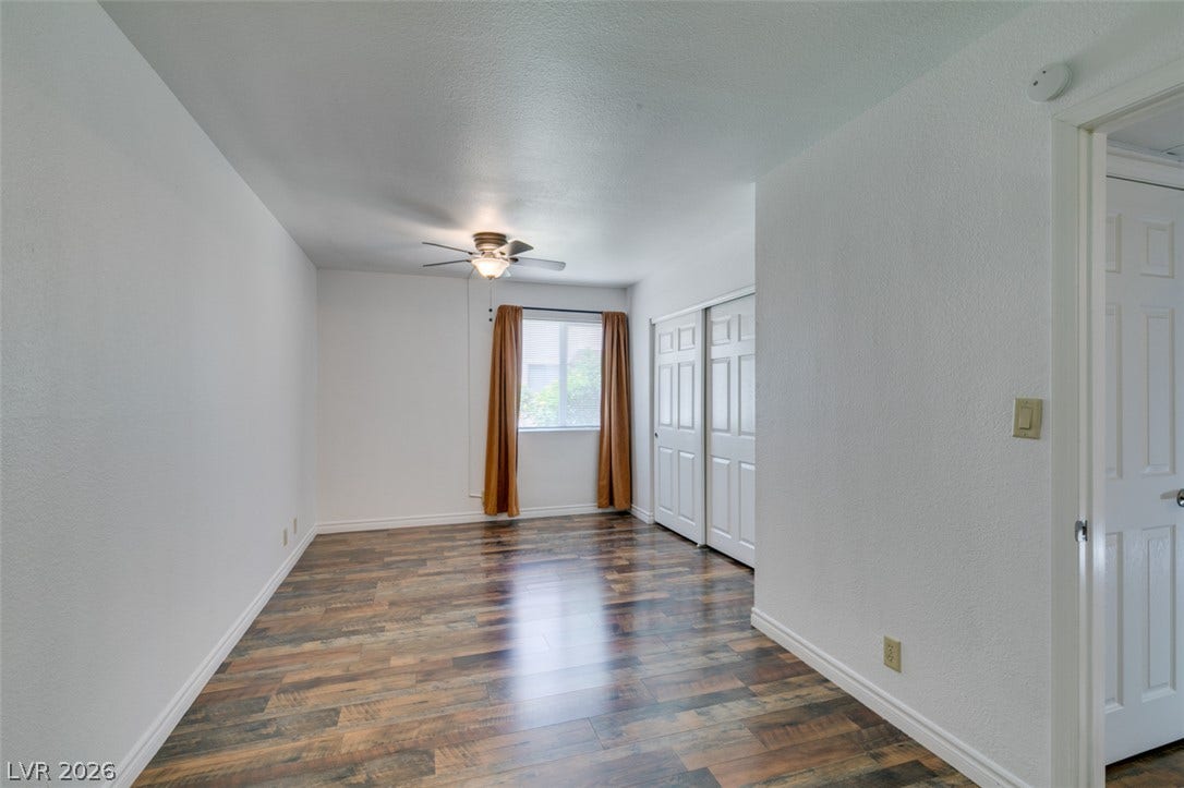 5240 Indian River Drive, #273, Las Vegas, NV 89103 Warm wood flooring grounds this versatile room featuring a classic multi-panel sliding closet.