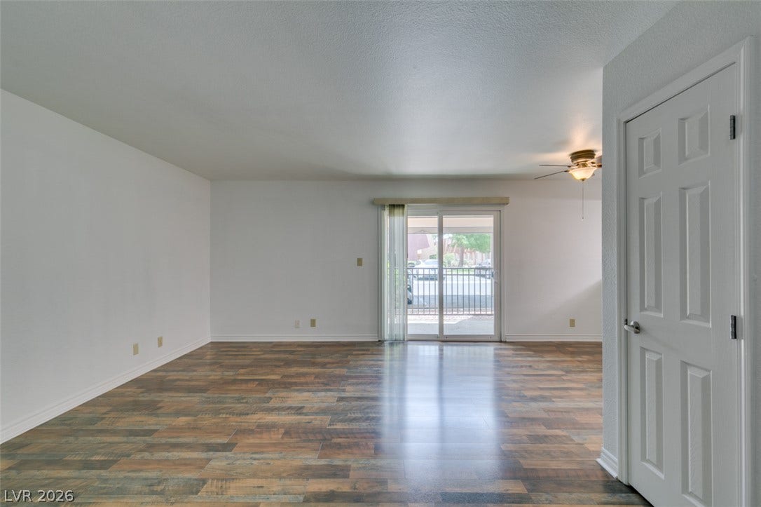 5240 Indian River Drive, #273, Las Vegas, NV 89103 A sliding glass door opens to the outdoors from this versatile space with wood-style flooring.