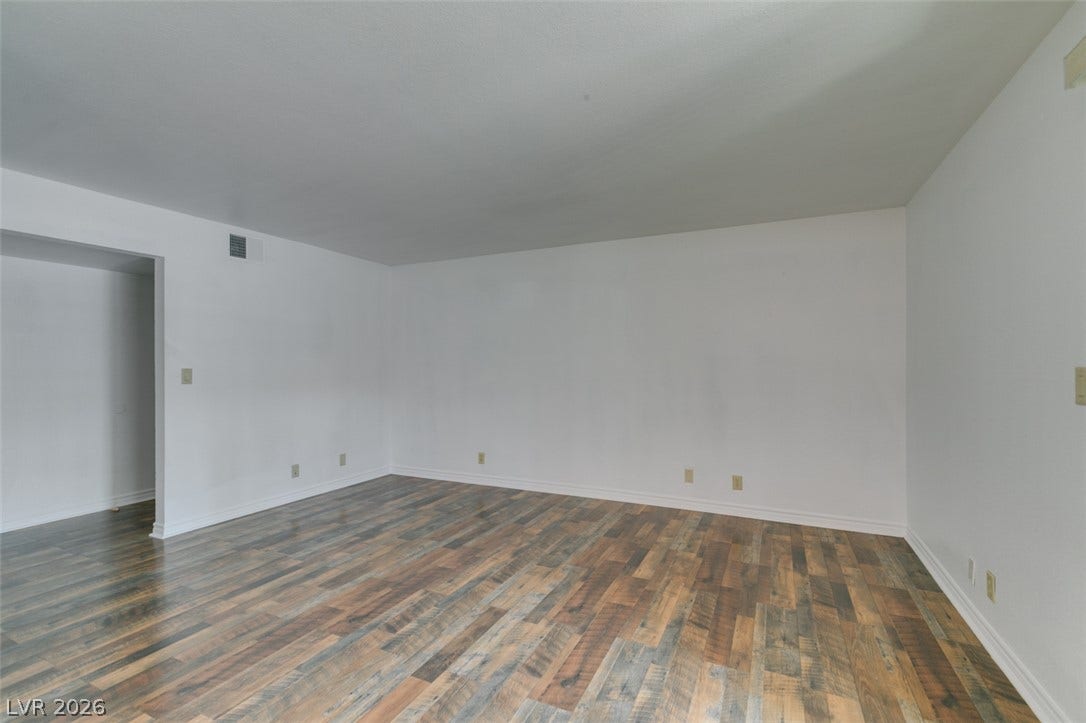 5240 Indian River Drive, #273, Las Vegas, NV 89103 Richly textured wood-look flooring anchors this versatile open living space.