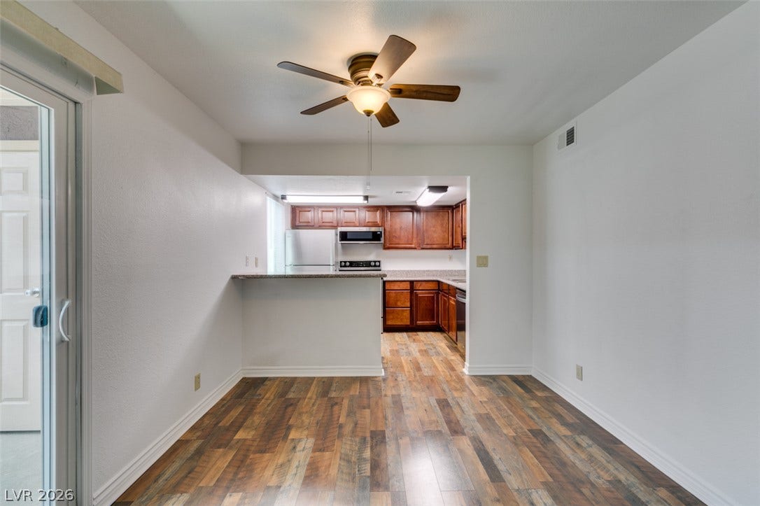5240 Indian River Drive, #273, Las Vegas, NV 89103 Rich wood-look flooring anchors a dining space connected directly to the kitchen area.