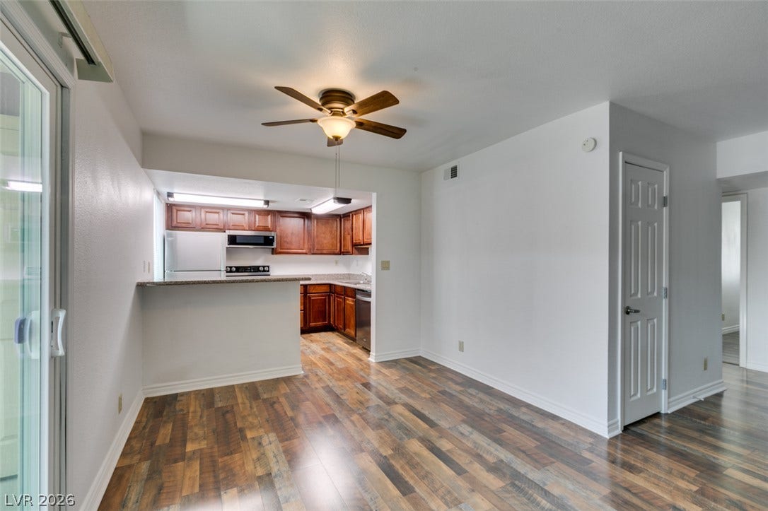 5240 Indian River Drive, #273, Las Vegas, NV 89103 An open floorplan seamlessly connects the dining space with the kitchen featuring handsome wood floors.