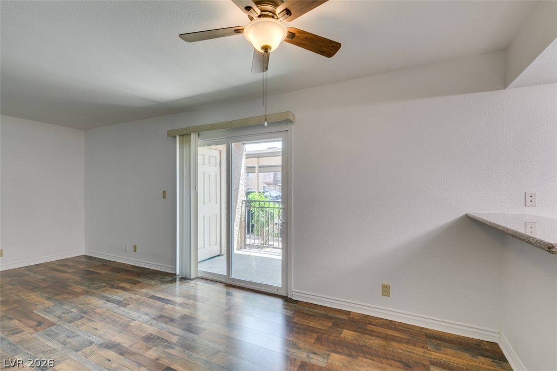 5240 Indian River Drive, #273, Las Vegas, NV 89103 Gleaming wood floors anchor this open living area featuring sliding glass doors to a balcony.