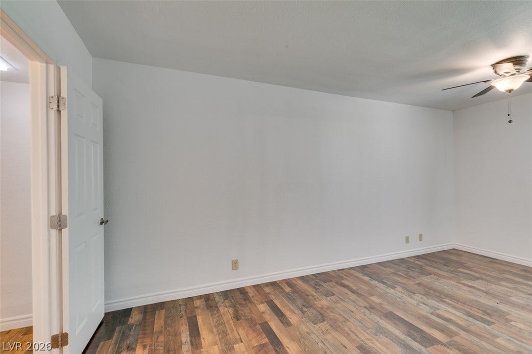 5240 Indian River Drive, #273, Las Vegas, NV 89103 Rich wood-look flooring and clean neutral walls anchor this versatile interior space.