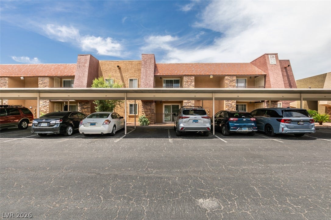 5240 Indian River Drive, #273, Las Vegas, NV 89103 Multi-level residential building features designated covered carport parking spaces directly in front of the entryways.