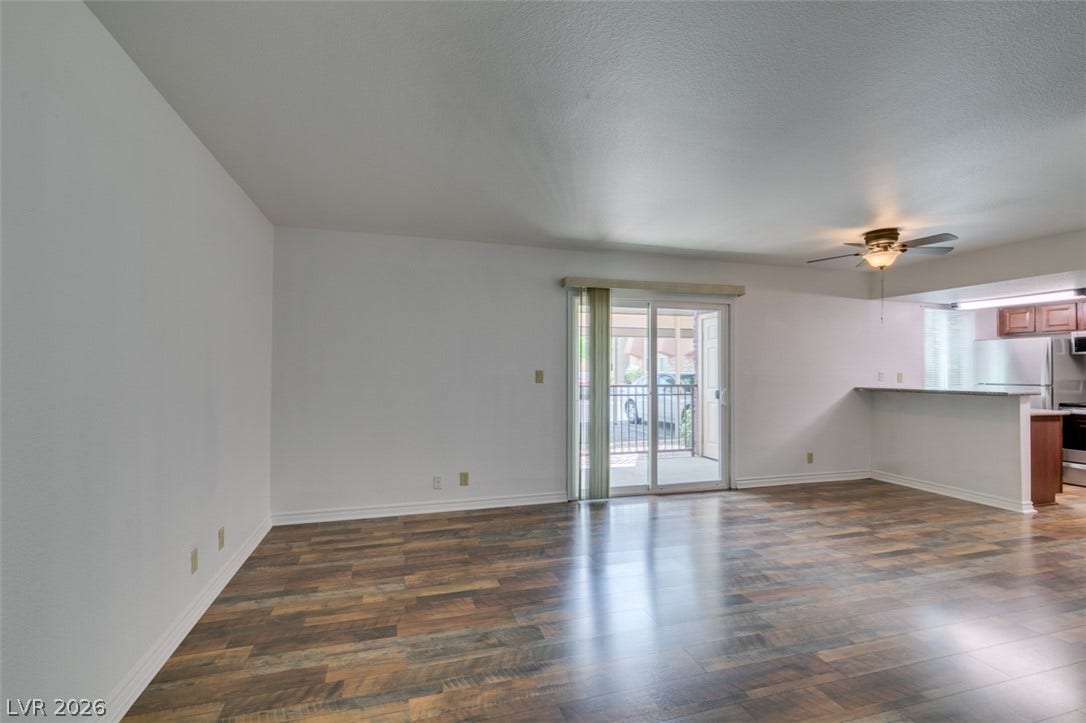 5240 Indian River Drive, #273, Las Vegas, NV 89103 Gleaming wood-look floors anchor a versatile living space leading directly to a private balcony.