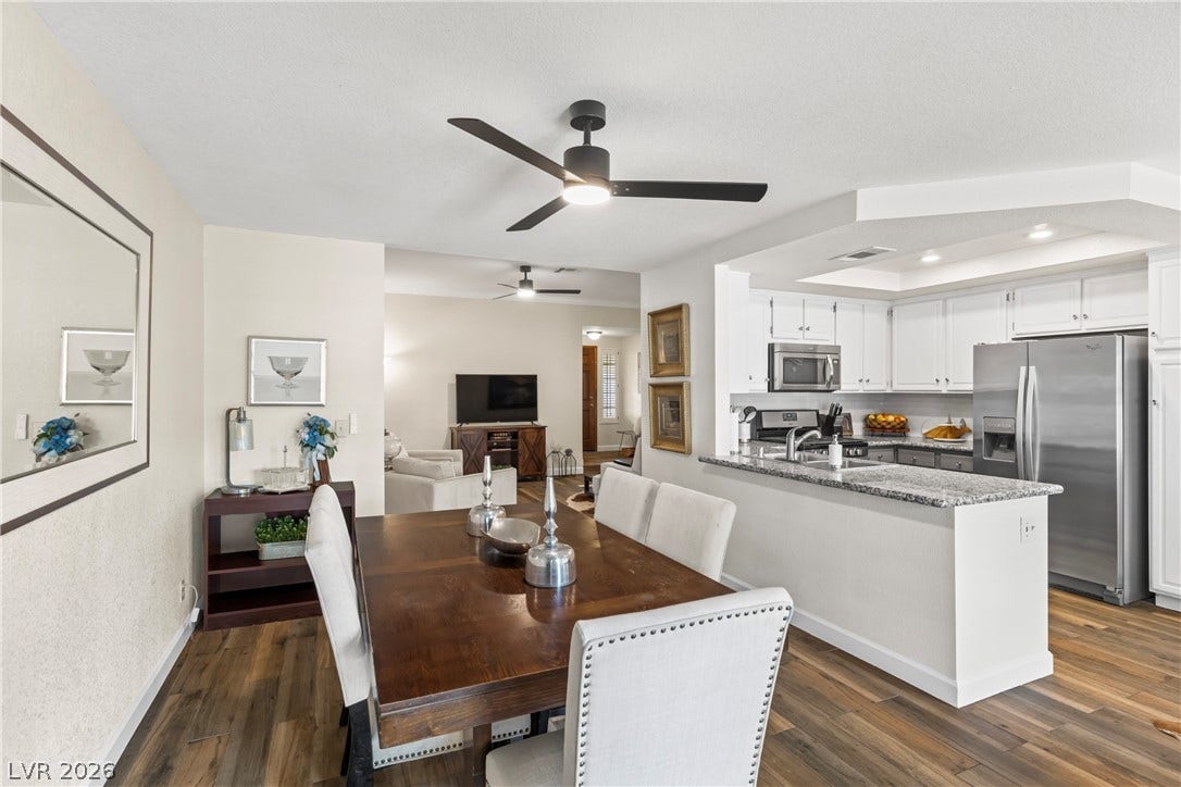 Gleaming hardwood floors and a modern open floorplan seamlessly connect the dining space and kitchen.