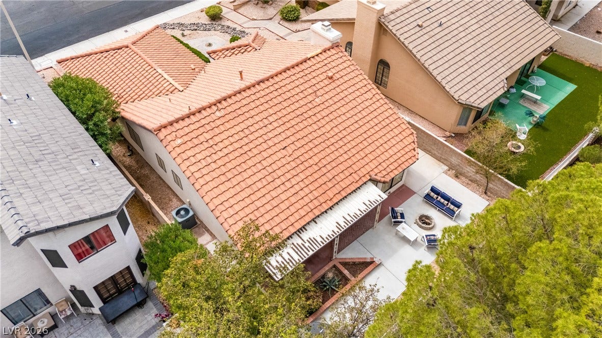 An aerial perspective showcases the classic barrel tile roofing and private rear courtyard space.