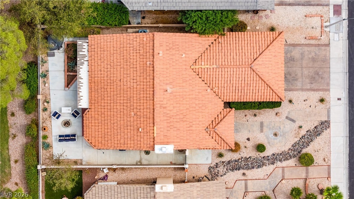 An aerial perspective showcases the classic tile roof structure and neat surrounding hardscaping.