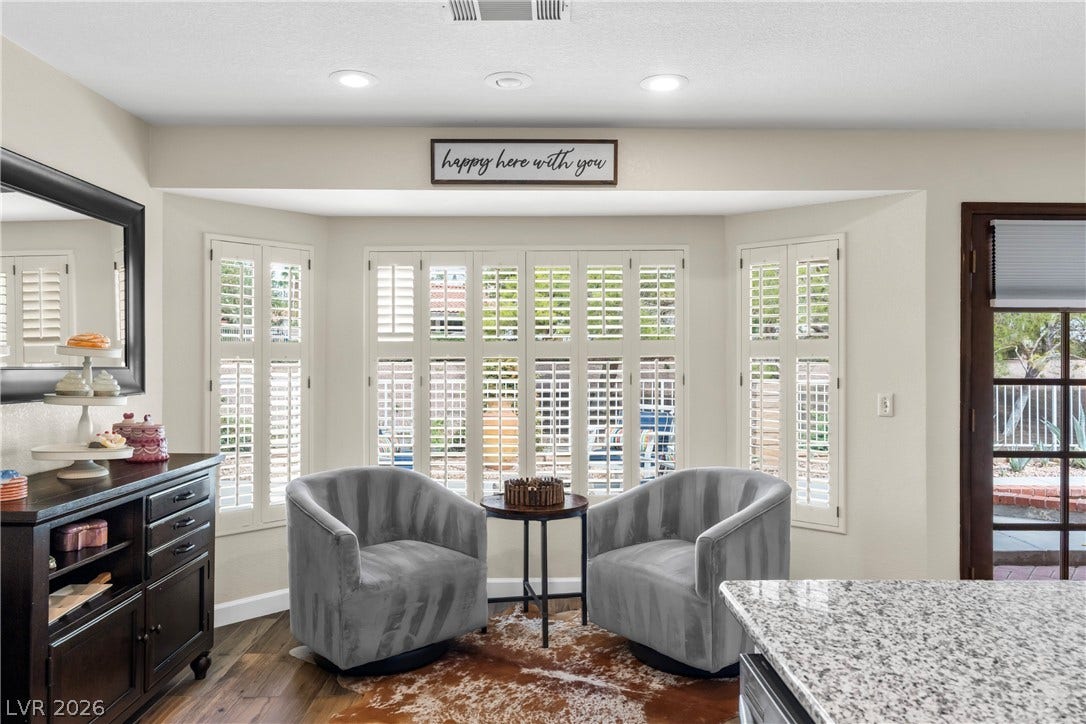Recessed lighting and a classic bay window create a serene setting off the kitchen.