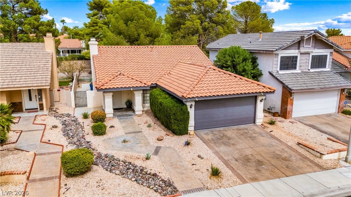 A classic tile roof and low-maintenance desert landscaping welcome you to this charming home.