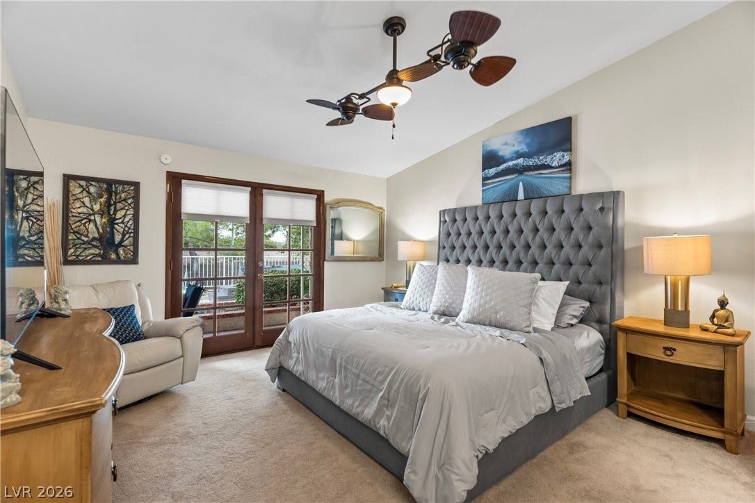 Glass doors bring natural light into this comfortable retreat with wall-to-wall carpeting.