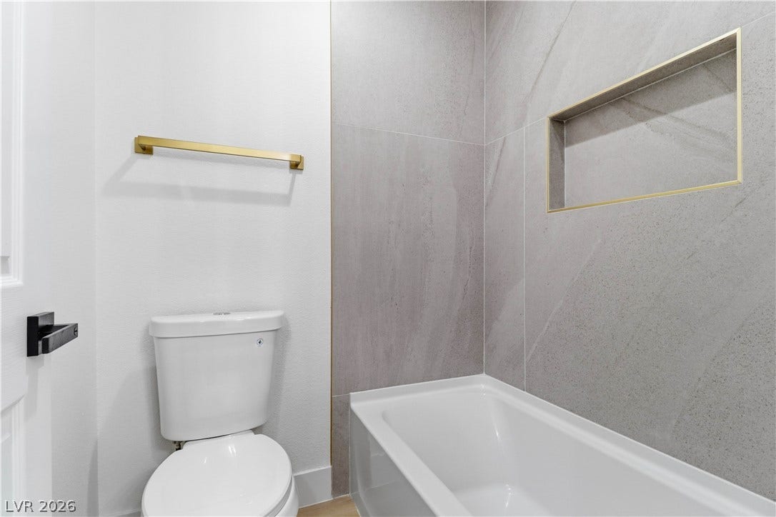 5150 Villa Dante Avenue, Las Vegas, NV 89141 Elegant tile surrounds the deep soaking tub in this beautifully designed modern bathroom.