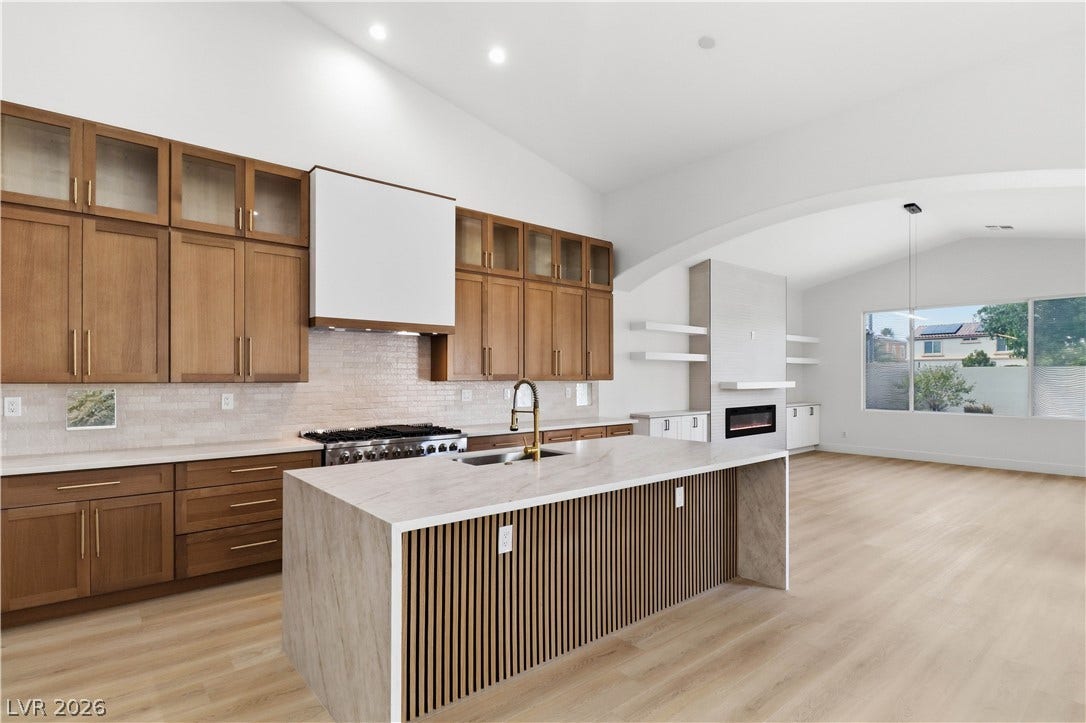 5150 Villa Dante Avenue, Las Vegas, NV 89141 A spacious kitchen flows seamlessly into the main living areas on light wood floors.