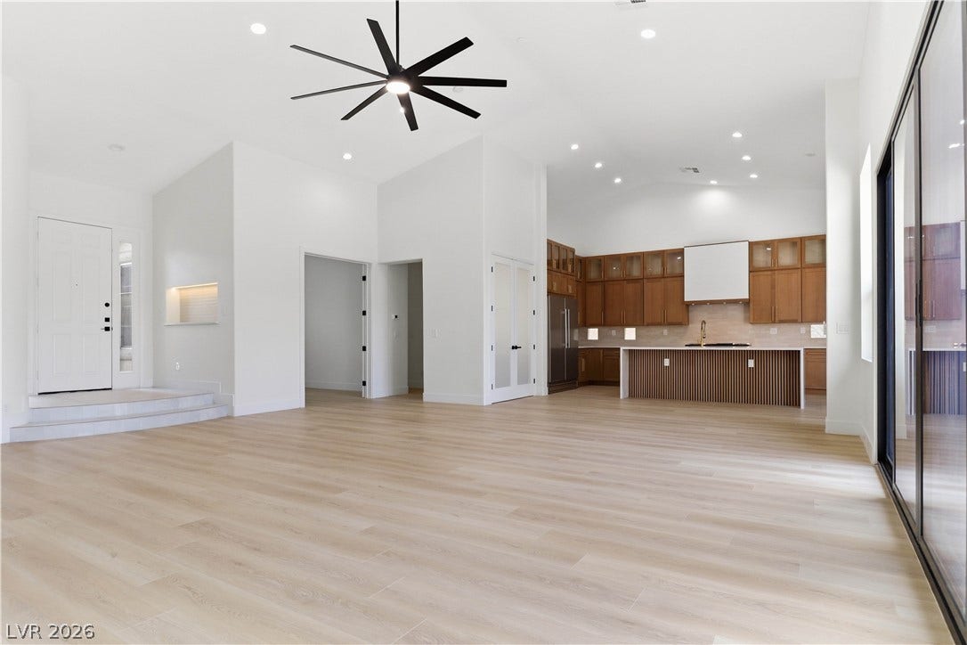 5150 Villa Dante Avenue, Las Vegas, NV 89141 A spacious layout showcases soaring ceilings, light wood floors, and a modern kitchen.