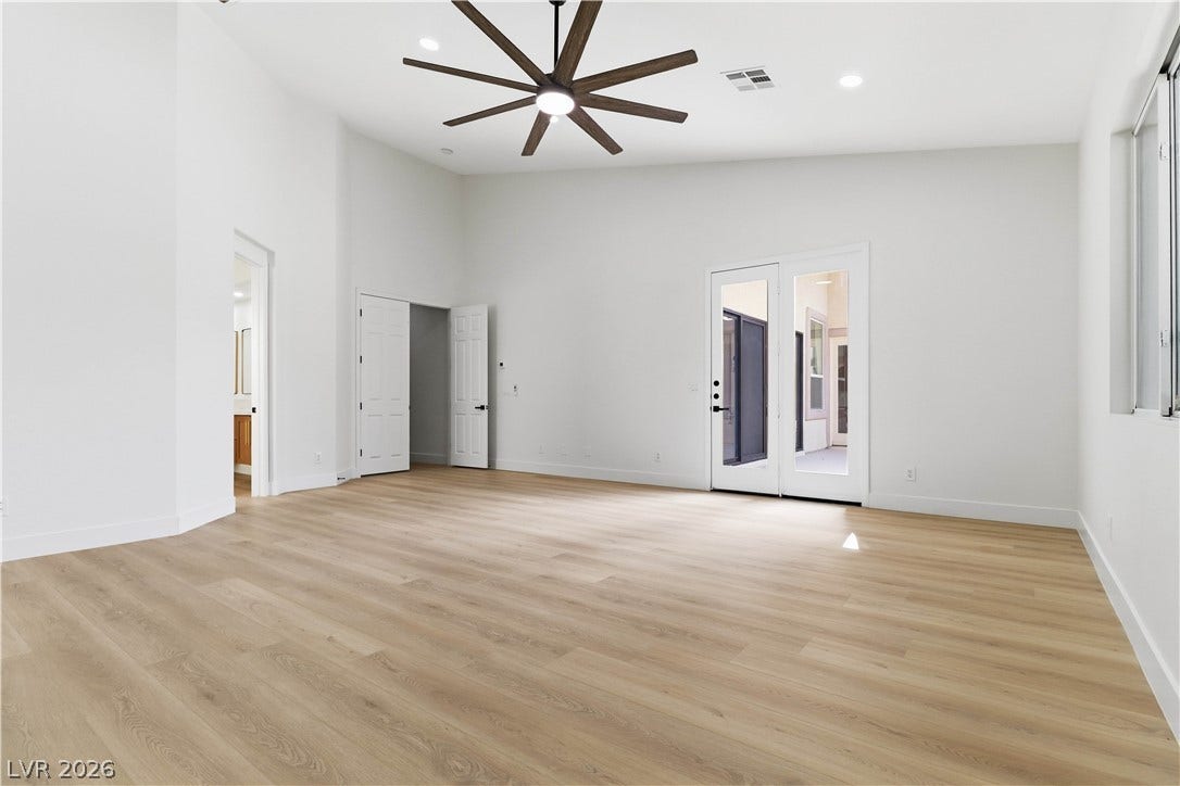 5150 Villa Dante Avenue, Las Vegas, NV 89141 High ceilings and clean plank flooring create a modern, airy atmosphere in this versatile room.