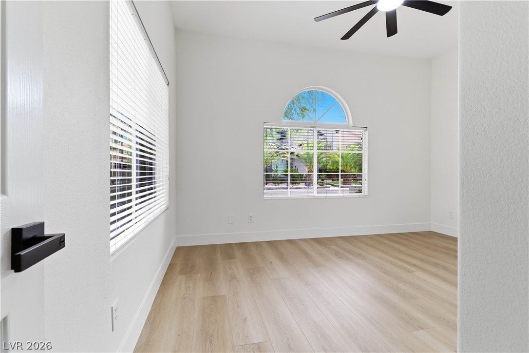 5150 Villa Dante Avenue, Las Vegas, NV 89141 Arched window detailing and smooth wood flooring define this versatile interior space.