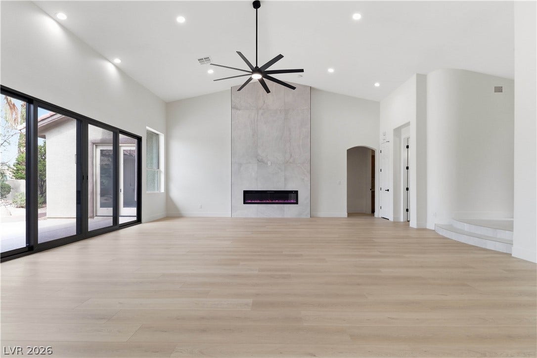5150 Villa Dante Avenue, Las Vegas, NV 89141 Sleek hardwood floors and a modern fireplace define this open living space.
