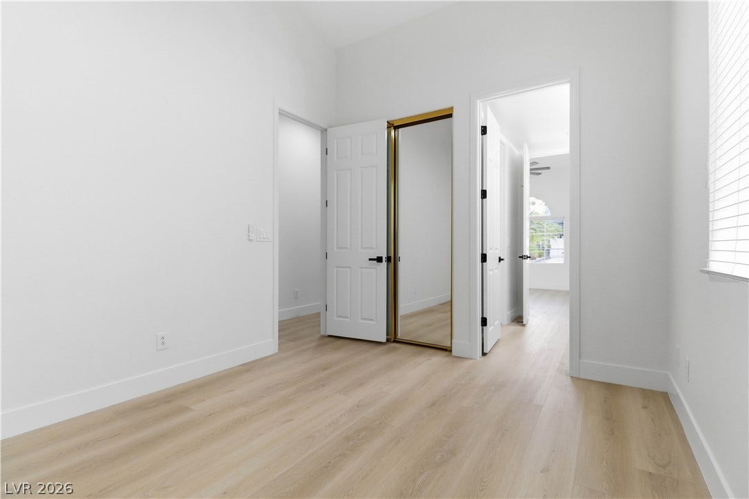 5150 Villa Dante Avenue, Las Vegas, NV 89141 Smooth wood floors and crisp white walls create a clean, minimalist interior canvas.
