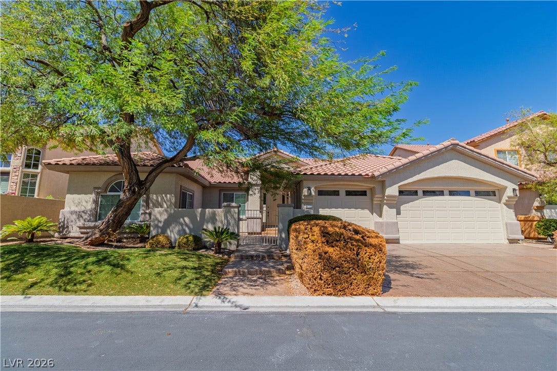 5150 Villa Dante Avenue, Las Vegas, NV 89141 Spanish tile roofing and structured stucco walls highlight this classic desert exterior design.