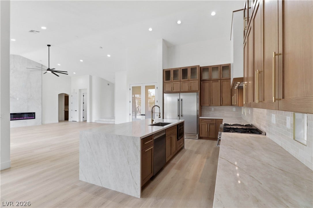 5150 Villa Dante Avenue, Las Vegas, NV 89141 Streamlined modern cabinetry and premium stone countertops define this airy open-concept space.