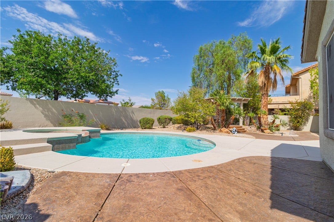 5150 Villa Dante Avenue, Las Vegas, NV 89141 A sparkling swimming pool highlights this backyard retreat surrounded by mature landscaping and concrete decking.