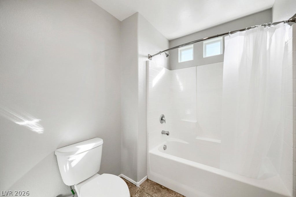 7241 Glistening Star Street, North Las Vegas, NV 89084 High clerestory windows bring soft natural light into a modern tub and shower alcove.
