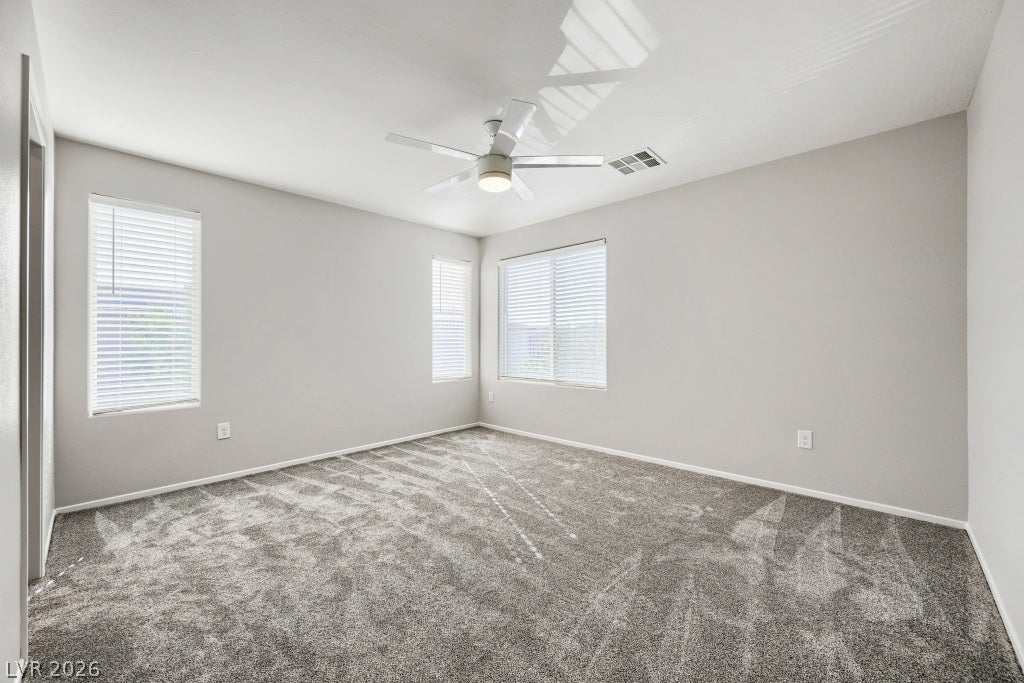 7241 Glistening Star Street, North Las Vegas, NV 89084 Plush carpeting anchors this versatile room illuminated by multiple windows.