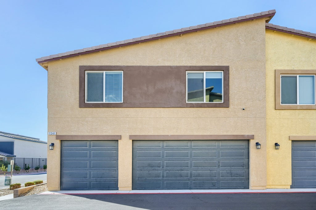 7241 Glistening Star Street, North Las Vegas, NV 89084 Modern multi-car garage doors anchor the clean-lined stucco exterior of this contemporary townhouse.