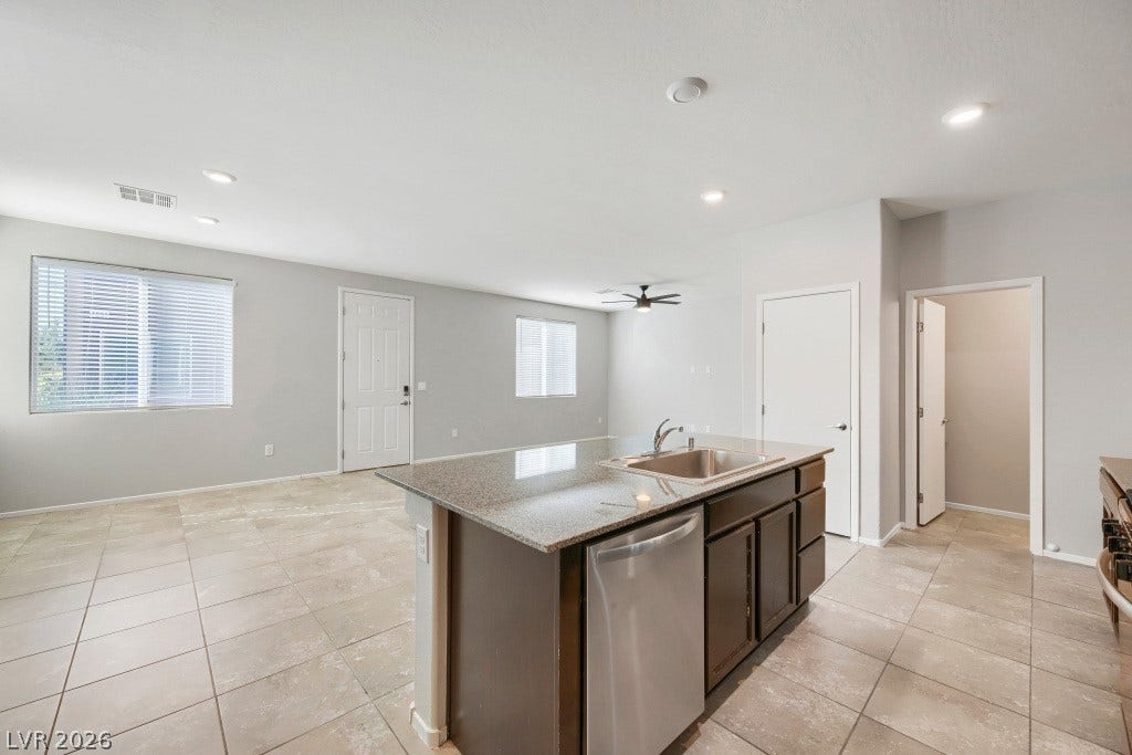 7241 Glistening Star Street, North Las Vegas, NV 89084 An open kitchen layout flows seamlessly into the surrounding living areas over tile flooring.