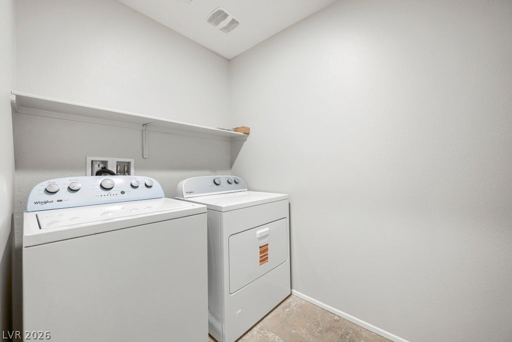 7241 Glistening Star Street, North Las Vegas, NV 89084 Functional utility space features durable flooring and a built-in storage shelf above the laundry units.