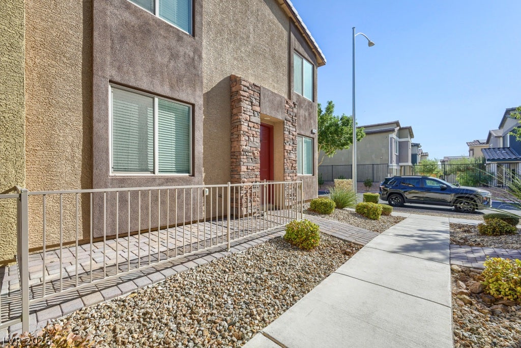 7241 Glistening Star Street, North Las Vegas, NV 89084 Neat stone details trim the exterior of this modern, multi-level home with paved walkways.
