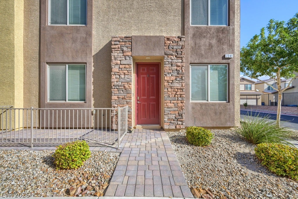 7241 Glistening Star Street, North Las Vegas, NV 89084 A stone-accented entryway leads to a secure front entrance framed by dual windows.