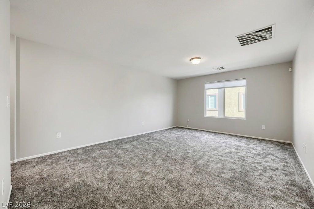 7241 Glistening Star Street, North Las Vegas, NV 89084 Plush wall-to-wall carpeting and neutral walls define this versatile upstairs room.